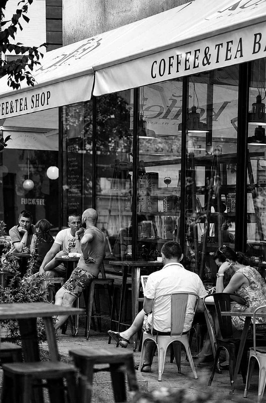 Guests at Koffein's terrace under the branded coffee and tea bar awning